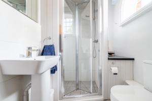 a bathroom with a shower and a sink at Ballygate Stable in Beccles
