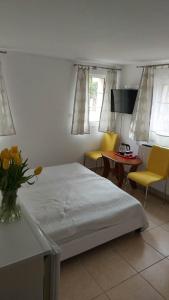 a bedroom with a bed and a table and chairs at Pokoje w Kołobrzegu in Kołobrzeg