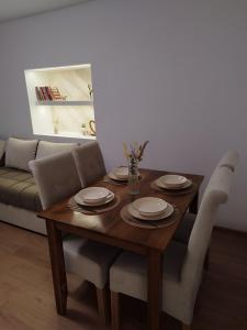 a wooden table with chairs and a dining room at Apartman Limski Kutak in Železnička Stanica Prijepolje +6 photos