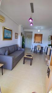 a living room with a couch and a table at Magic World Aguamarina in Oropesa del Mar