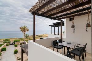 a patio with a table and chairs and the ocean at Villa Sunrise by the Sea in Kiotari