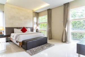 a bedroom with a bed and a large window at Morning Glory Mountain View Villa 4 Bedrooms With a Private Heated Swimming Pool in Bandung +43 photos