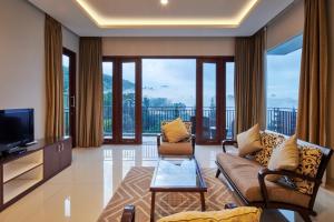 a living room with a couch and a tv at Morning Glory Mountain View Villa 4 Bedrooms With a Private Heated Swimming Pool in Bandung
