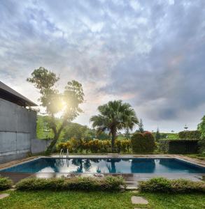 a swimming pool in the yard of a house at Morning Glory Mountain View Villa 4 Bedrooms With a Private Heated Swimming Pool in Bandung