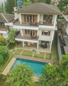 an aerial view of a house with a swimming pool at Morning Glory Mountain View Villa 4 Bedrooms With a Private Heated Swimming Pool in Bandung