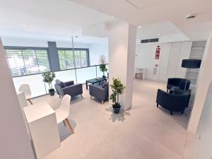 an office space with chairs and a table and a tablektop at HOTEL BESTPRICE Maragall in Barcelona