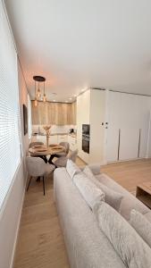 a living room with a couch and a table at Apartamentai Trakų centre in Trakai