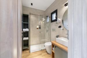 a bathroom with a shower and a toilet and a sink at Selva Cabins in Zărneşti +133 photos