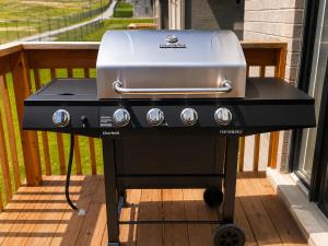 a grill sitting on a deck on a porch at Luxury 5 Bed Retreat for 12 with Gourmet Kitchen in Paris