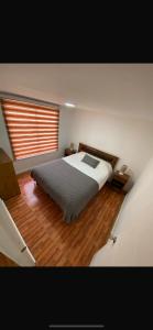 a bedroom with a bed and a large window at Ritoque lodge in Vina del Mar