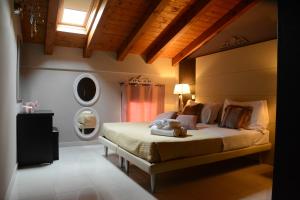 a bedroom with a large bed with a window at Villa Giotto Luxury Suite & Apartments in Mestre