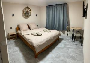a bedroom with a bed with two pillows on it at Apartments House Pylypets in Pilipets