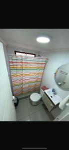 a small bathroom with a toilet and a sink at Ritoque lodge in Vina del Mar