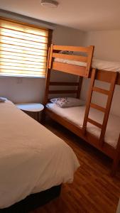 a bedroom with two bunk beds and a window at Ritoque lodge in Vina del Mar