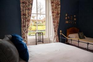 a bedroom with a bed and a window at Leven House Bed and Breakfast in Crieff
