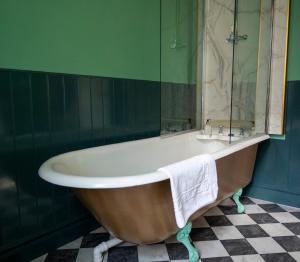 a bath tub in a bathroom with a green wall at Leven House Bed and Breakfast in Crieff +76 photos