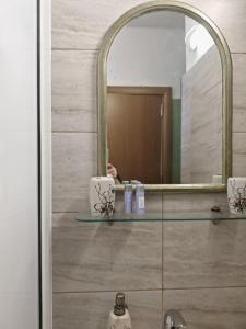 a bathroom with a mirror and a sink at Guest House Plavas in Sozopol +188 photos