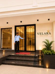 a man standing in front of a building at Velara Hotel & Banquet in Gwalior