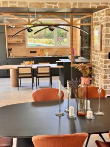 a kitchen and dining room with a table and chairs at Ty Toralann in Guipavas