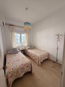 a bedroom with two beds and a window at andaluz in La Mamola
