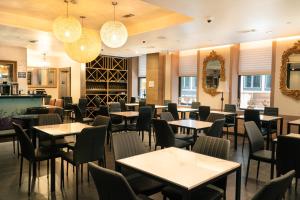 a dining room with tables and chairs and lights at Hotel Stanford in New York +38 photos