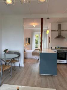 a living room with a kitchen and a bedroom at St Guenole' Studio Apartment in Landévennec