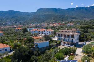a view of a village with mountains in the background at Laloudaki Apartments in Tyros