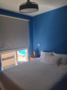 a blue bedroom with a bed and a blue wall at Albir Sunshine Apartments in Albir +30 photos