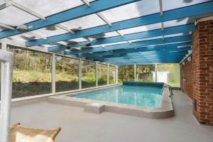 a swimming pool with a blue ceiling at 2808-Romo-Lejrbjergvej-4 in Høm