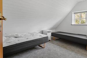 a bedroom with two beds and a window at 2808-Romo-Lejrbjergvej-4 in Høm +33 photos