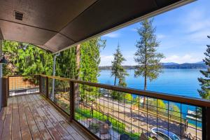 a balcony with a view of a lake at Hayden Lake Oasis in Hayden