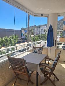 a table and chairs on a balcony with a view at Albir Sunshine Apartments in Albir