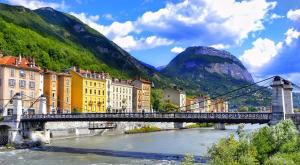 a bridge over a river with buildings and a mountain at Duplex cosy 4-6 pers - Terrasse - Grenoble - Vercors in Claix +10 photos