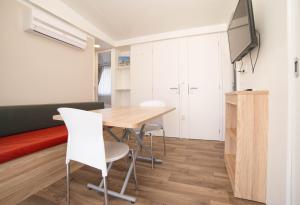 a dining room with a table and chairs at Safari Beach & Camping in Donji Štoj
