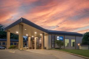 a gas station with a cloudy sky behind it at Best Western Vicksburg in Vicksburg