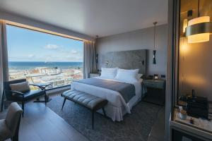 a hotel room with a bed and a large window at Hotel Cabo De Hornos in Punta Arenas +83 photos