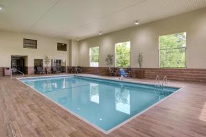 a large swimming pool in a building with a child in front at Best Western Vicksburg in Vicksburg