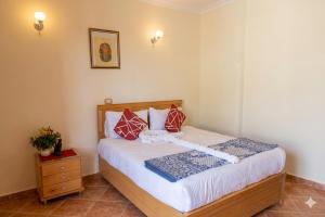 a bedroom with a bed with red pillows on it at Morning Star Apartment in Luxor