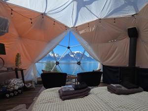 a bedroom with a tent with a view of a mountain at Lyngenfjord View in Engnes +11 photos