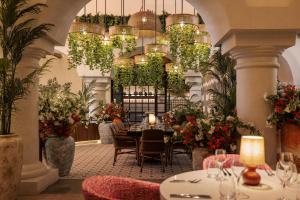 a restaurant with tables and chairs and plants at Hyatt Zilara Cancun - All Inclusive - Adults Only in Cancún +139 photos