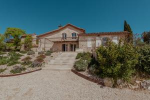 a stone house with a staircase in front of it at Vila Cabanes 46 in Le Montat