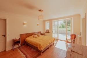 a bedroom with a bed and a large window at Vila Cabanes 46 in Le Montat