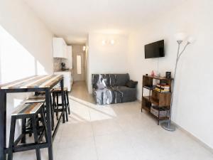 a living room with a table and a couch at Location Cap d'Agde Aurélie in Cap d'Agde