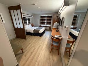 a hotel room with a bed and a desk at Microtel Inn & Suites in Dickson City