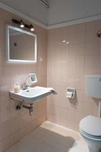 a bathroom with a sink and a toilet at Laloudaki Apartments in Tyros +50 photos