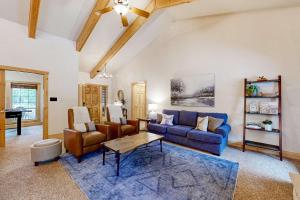 a living room with a blue couch and a table at Sunset Cabin in McCall +24 photos