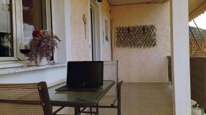 a laptop computer sitting on a table in a room at Laloudaki Apartments in Tyros