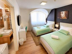 a hotel room with two beds and a sink at Hévíz Springs - Kehidakustány in Kehidakustány +44 photos