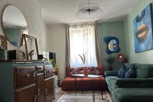a living room with a couch and a chair at YOUSRA Appartement in Poitiers