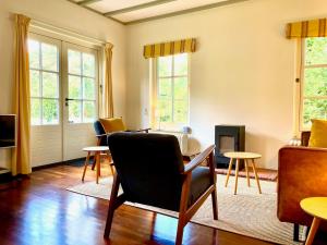 a living room with a chair and a fireplace at Gastenhuis Deurnink in Vorden